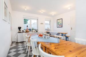 a kitchen and dining room with a wooden table and chairs at Regatta in Chłopy