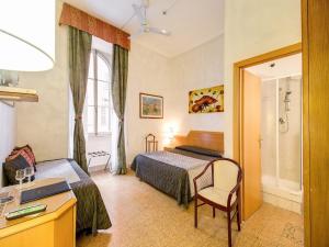 Postel nebo postele na pokoji v ubytování Hotel Giotto Flavia