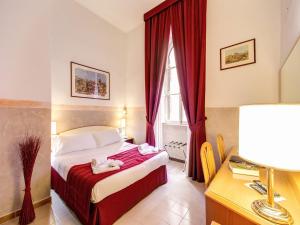 Postel nebo postele na pokoji v ubytování Hotel Giotto Flavia
