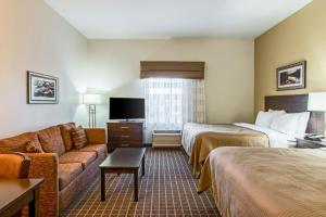 a hotel room with two beds and a couch at Sleep Inn & Suites West-Near Medical Center in Rochester
