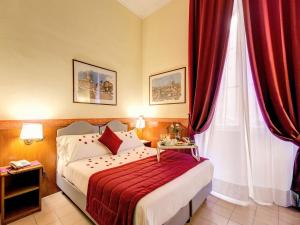 Postel nebo postele na pokoji v ubytování Hotel Giotto Flavia
