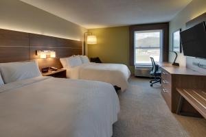 a hotel room with two beds and a flat screen tv at Holiday Inn Express - Horse Cave, an IHG Hotel in Horse Cave
