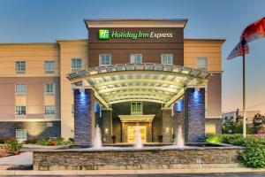 a hotel with a fountain in front of a building at Holiday Inn Express & Suites Cheektowaga North East, an IHG Hotel in Cheektowaga