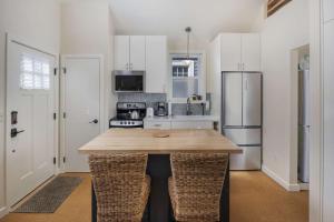 a kitchen with a wooden island in the middle at Castle Cottage in Portland
