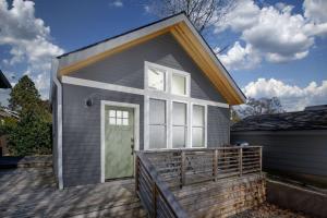 a tiny house with a porch and a door at Castle Cottage in Portland