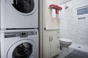 a bathroom with a washing machine and a toilet at Castle Cottage in Portland