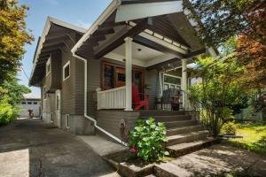 a small house with a porch with a red chair at Southeast Portland Retreat in Portland
