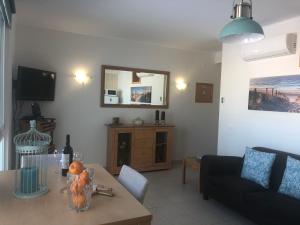 a living room with a table and a couch at Bayview Apartment 106 in Albufeira