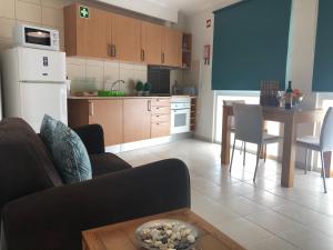 a kitchen with a couch and a table in a kitchen at Bayview Apartment 106 in Albufeira