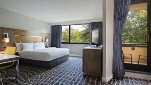 
a hotel room with a large bed and a large window at Hyatt Regency Princeton in Princeton
