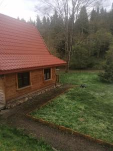 a log cabin with a red roof at Magellan Domki in Cisna