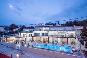 a large building with a swimming pool in front of it at Rent House Diamond in Iraklitsa