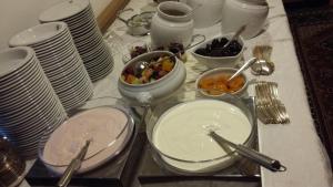 a table with plates and bowls of food on it at Christeinerhof in Santa Cristina Gherdëina