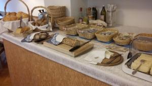 a counter with bread and baskets of food on it at Christeinerhof in Santa Cristina in Val Gardena