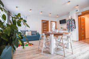 a kitchen and living room with a table and chairs at Szara Gora in Groń