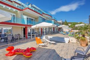 a resort with a pool with chairs and umbrellas at Rent House Diamond in Iraklitsa