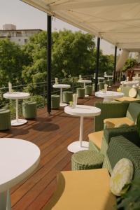 a patio area with tables, chairs and umbrellas at Condesa DF in Mexico City