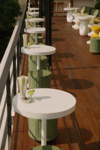 a row of white chairs sitting on top of a wooden deck at Condesa DF in Mexico City