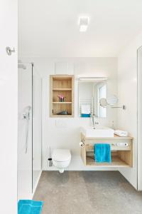 a bathroom with a sink and a toilet and a mirror at Gästehaus Bauer - Schlafen auf dem Weingut in Heilbronn