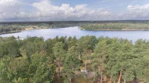 an aerial view of a lake with a house at Eremitstuga Detox resort in Köpmannebro