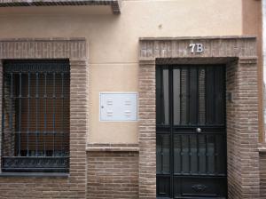 two doors with the number on the side of a building at El LEGADO in Andújar