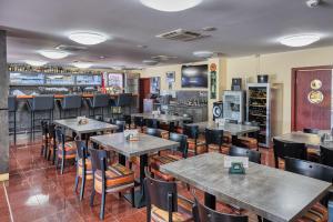 a restaurant with tables and chairs and a bar at Hotel Arena in Chomutov