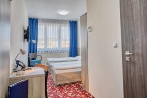 Ένα ή περισσότερα κρεβάτια σε δωμάτιο στο Hotel Arena