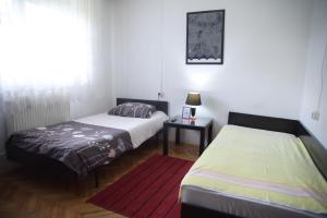 a bedroom with two beds and a window at Petrograd in Bitola