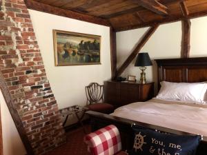 a bedroom with a bed and a brick wall at The 1708 House in Southampton