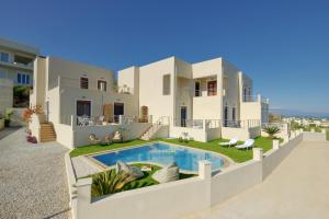 a villa with a swimming pool in front of a house at "Oak Wood" - Sea View Holidays Home by Sky Hill Resorts in Sfakaki