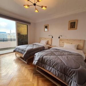 Ένα ή περισσότερα κρεβάτια σε δωμάτιο στο Madina Hostel