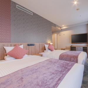 Postelja oz. postelje v sobi nastanitve ART HOTEL Aomori