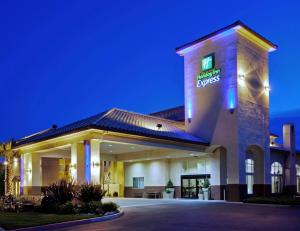 a hotel with a sign on the side of a building at Holiday Inn Express Madera by IHG in Madera