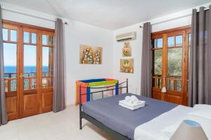 a bedroom with a bed with a view of the ocean at Villa Anna in Kallirákhi +35 photos