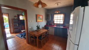 a kitchen with a wooden table and a refrigerator at Casa Marco in Puntagorda