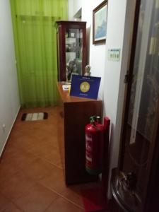 a room with a fire hydrant and a desk with a fire extinguisher at Ocean Studio in Peniche