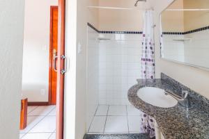 a bathroom with a sink and a shower at Pousada Danitato e lavanderia in Bom Jardim