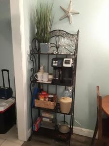 a shelf in a kitchen with various items on it at Benjamin's Pier at Laguna Reef Resort in Rockport