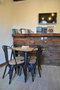 a table and chairs in a room with a tv at The Fox Hostel in Santiago