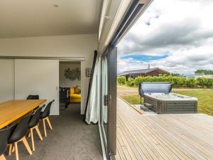a patio with a table and chairs on a deck at Mountain Adventure Spa Escape - Ohakune Home in Ohakune