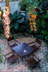a patio with a table and chairs and flowers at iuDia Hotel in Phra Nakhon Si Ayutthaya