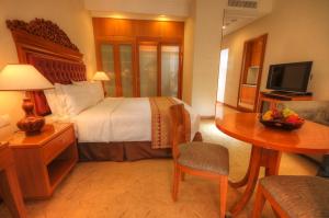 a hotel room with a bed and a table with a table at Royale Chulan Kuala Lumpur in Kuala Lumpur