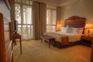 a bedroom with a large bed with a large window at Royale Chulan Kuala Lumpur in Kuala Lumpur