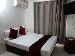 Letto o letti in una camera di Hotel Don Juan Colonial