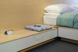 Postel nebo postele na pokoji v ubytování Sleeport