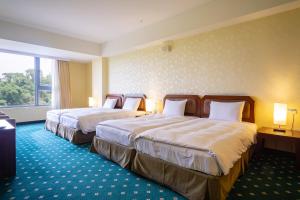 Postel nebo postele na pokoji v ubytování 柳營尖山埤 Liuying Jianshanpi Resort