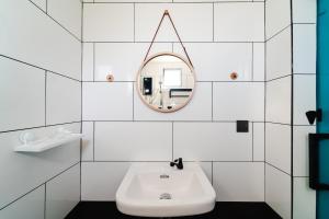 a white bathroom with a sink and a mirror at Perfect Hub Semporna in Semporna