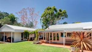 a house with a large yard in front of it at Merricks North Retreat in Merricks North