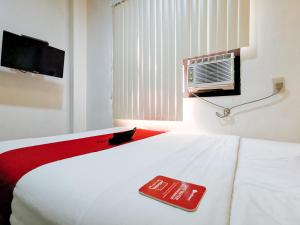 Ένα ή περισσότερα κρεβάτια σε δωμάτιο στο RedDoorz near Trade School Gensan