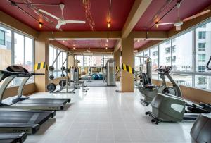 a gym with treadmills and elliptical machines at MeStyle Place in Bangkok